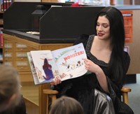 up close of theatre guild member reading book