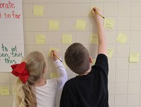 two students writing messages