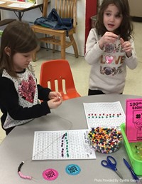 two students working on 100 days of school activity