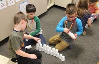 students building cup tower for 100 days of school activity