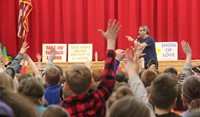 students raising hands