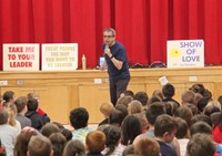 medium shot of presenter speaking with students