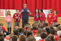 students singing into microphone