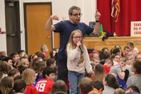 student singing into microphone