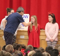 student speaking into microphone