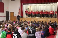 wide shot of mister vanderslice speaking to chenango bridge elementary students with high school stu