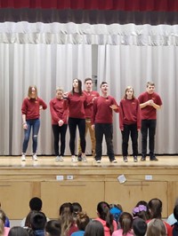 students performing on stage