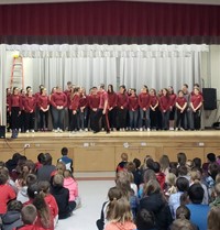 medium shot of high school students performing for chenango bridge elementary