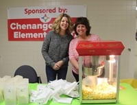 people next to popcorn machine