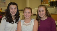 three students smiling