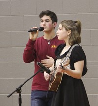 two high school students singing