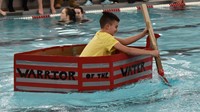 student competing in cardboard boat races