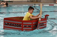 student competing in cardboard boat races