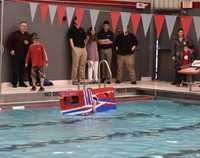 students competing in cardboard boat races