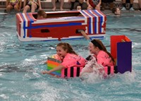 students competing in cardboard boat races