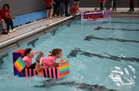 students competing in cardboard boat races