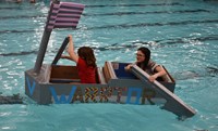 two students competing in cardboard boat races