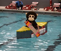 student competing in cardboard boat races