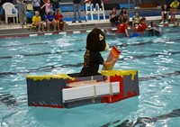 students competing in cardboard boat races