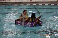 two students competing in cardboard boat races