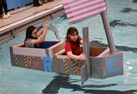 two students competing in cardboard boat races