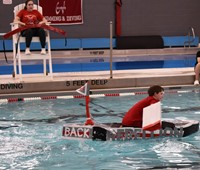 student competing in cardboard boat races