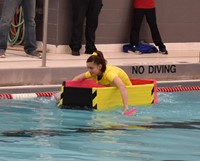 student competing in cardboard boat races