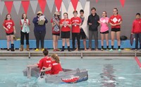 students competing in cardboard boat race