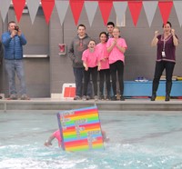 students competing in cardboard boat race
