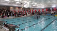 wide shot of students competing in cardboard boat race