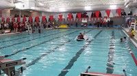 wide shot of students competing in cardboard boat race