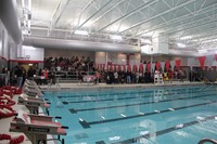 students of students entering pool area for cardboard boat races