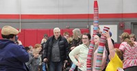 students taking picture with cups they stacked