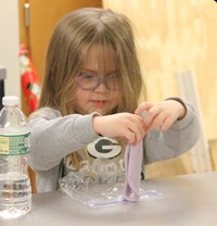 student taking part in activity involving silly putty