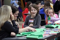 student and teachers taking part in activity involving cards