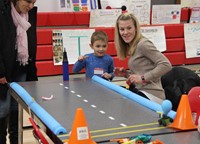 student taking part in p t a activity involving balloon raceway