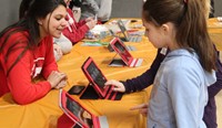 students looking at i pads for activity