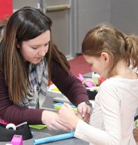 student and teacher building rocket for steam night activity