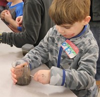 younger student trying magnetic experiment