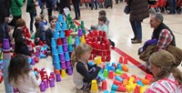 multiple students stacking cups