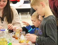 students taking part in activity involving honey