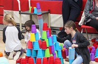 students stacking cup towers