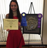 student next to artwork