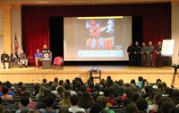 wide shot of presenter speaking at podium