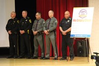 law enforcement officials standing next to no empty chair poster