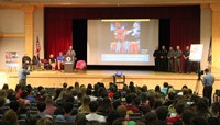 wide shot of law enforcement official speaking at no empty chair campaign kick off presentation