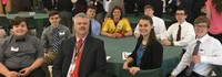 students sitting at table with teacher