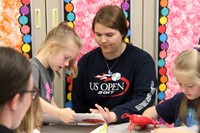 high school and middle school students reading to kindergarten students 9