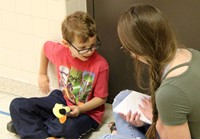 high school and middle school students reading to kindergarten students 2