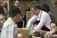 people serving ice cream